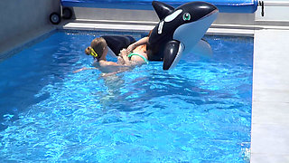 Lesbian Girls Are Having Fun in a Pool with an Inflatable Shark