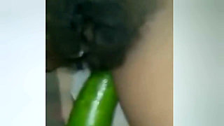 A Young Woman Is Inserting a Cucumber Into Her Pussy