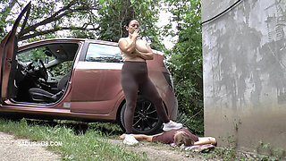 Mistress Jenna Stands on the Slave with a Car While Smoking in the Slave's Mouth